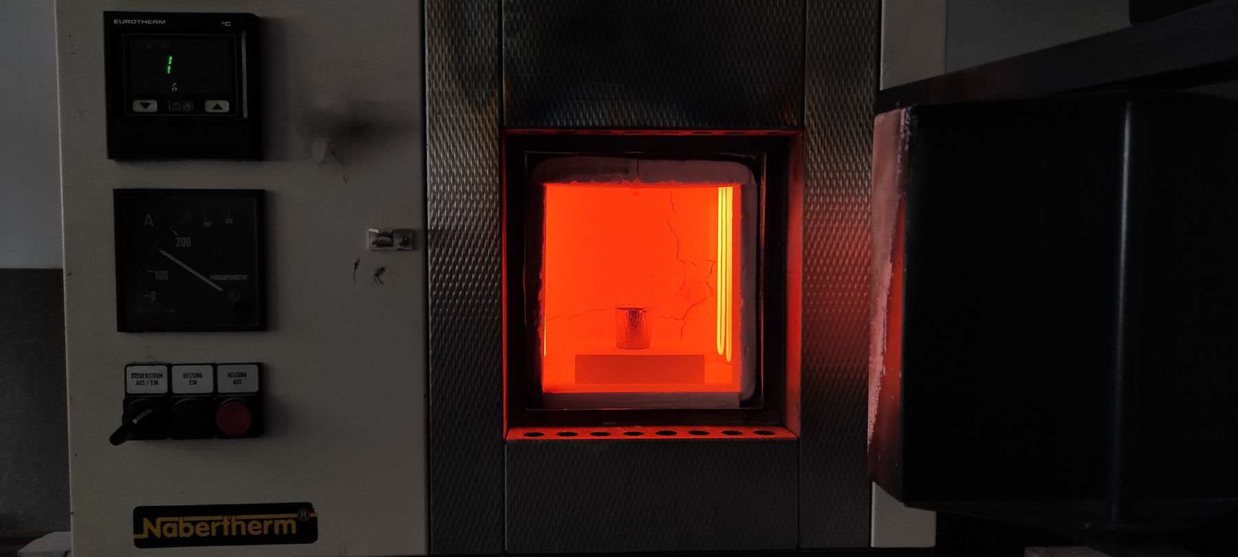 Open furnace glowing red with a crucible inside