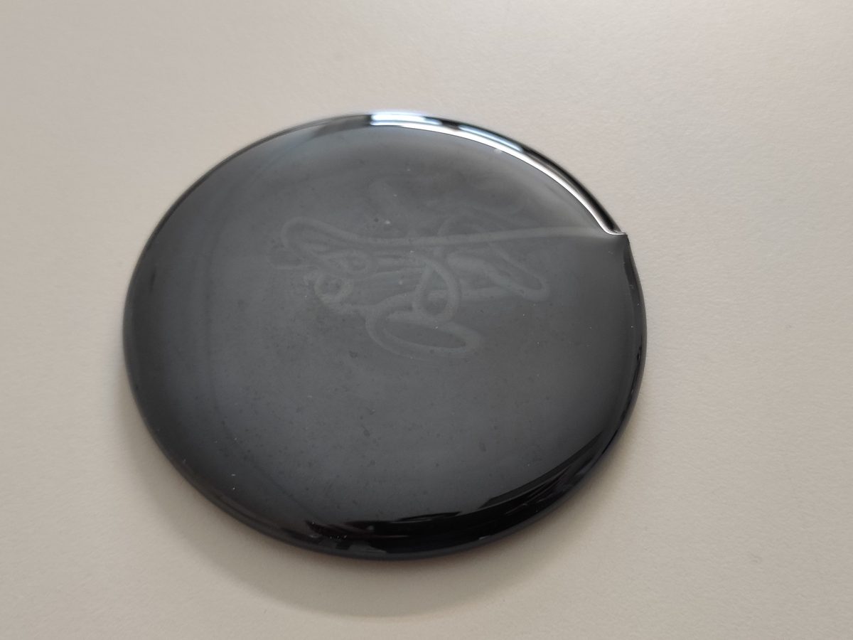 A polished disc of black volcanic glass